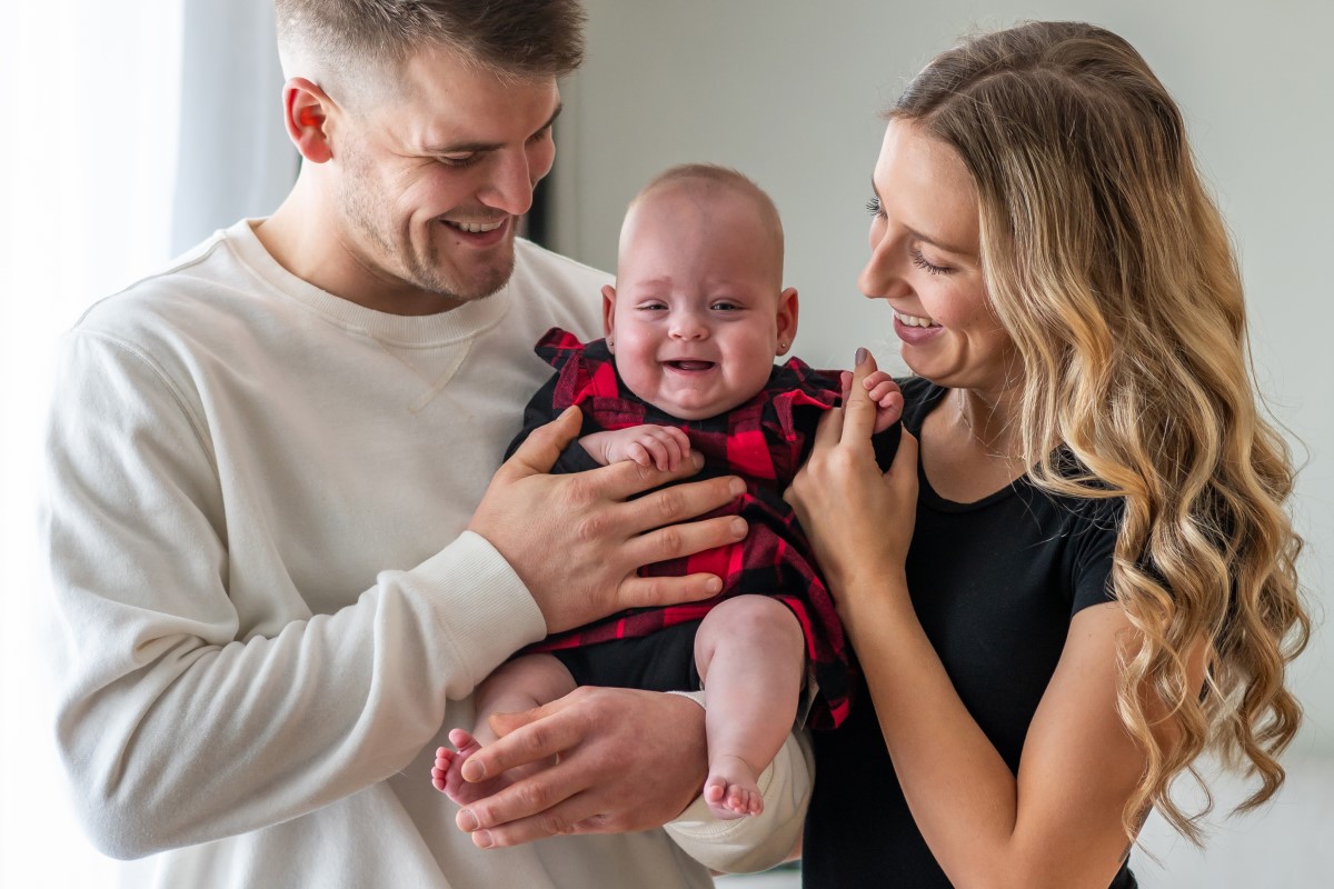 parents holding baby